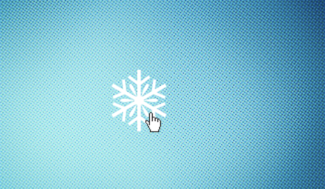 An image of a white snowflake sits on a blue computer screen with a little hand-shaped cursor about to click on it.