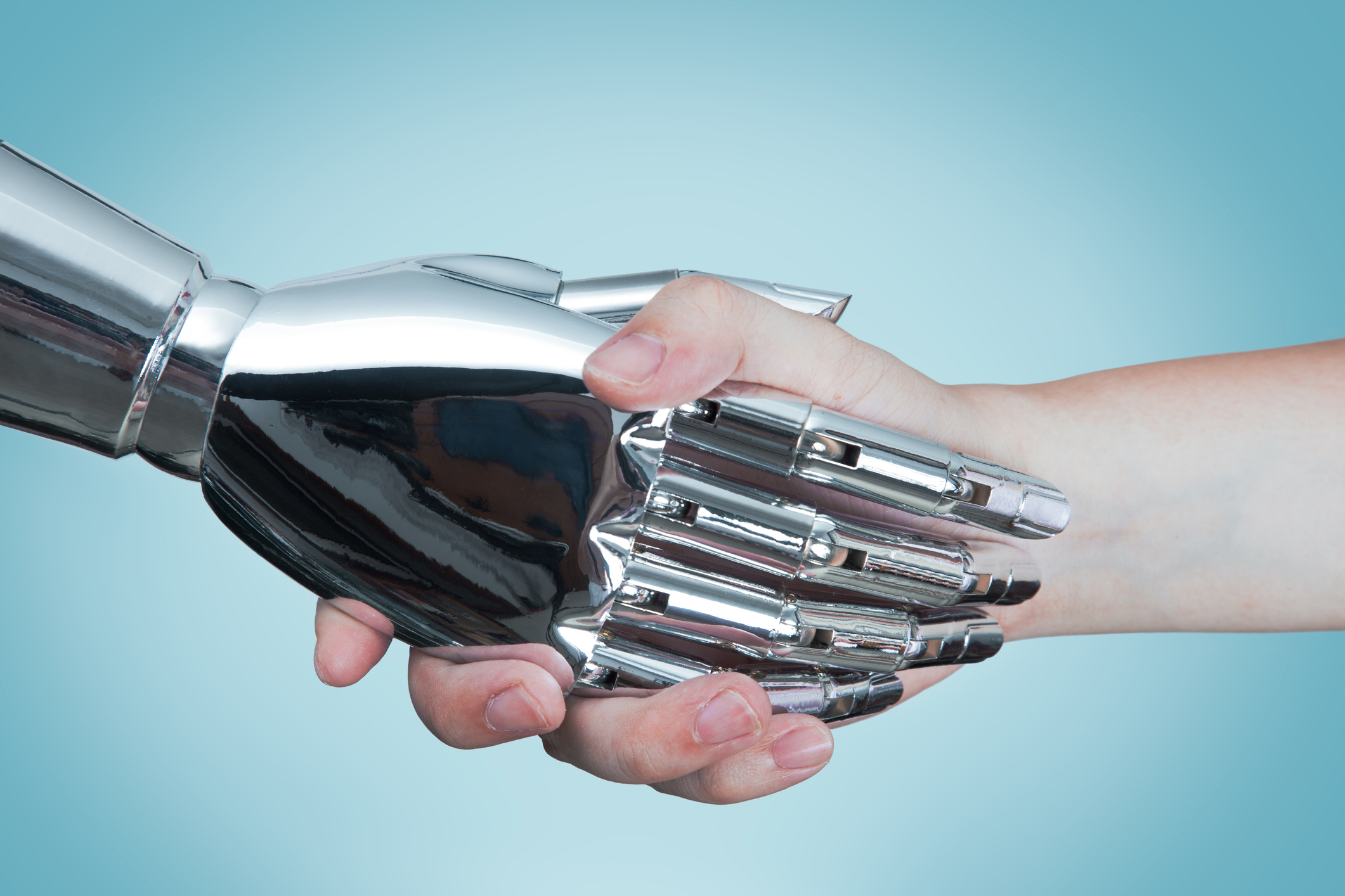 A closeup photo of a handshake between an AI robot and a human.