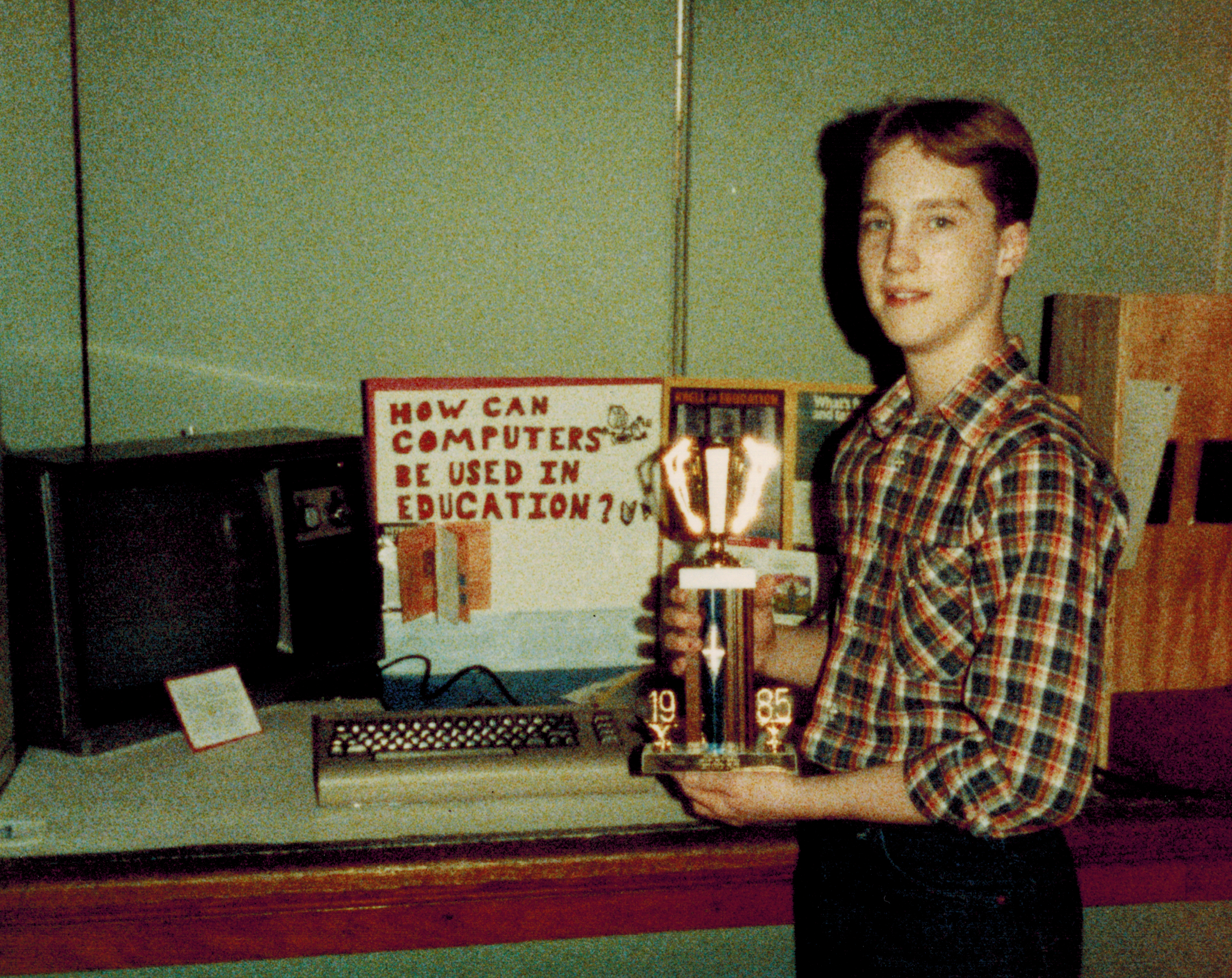 Ashley McGlone holding trophy at science fair in 1985